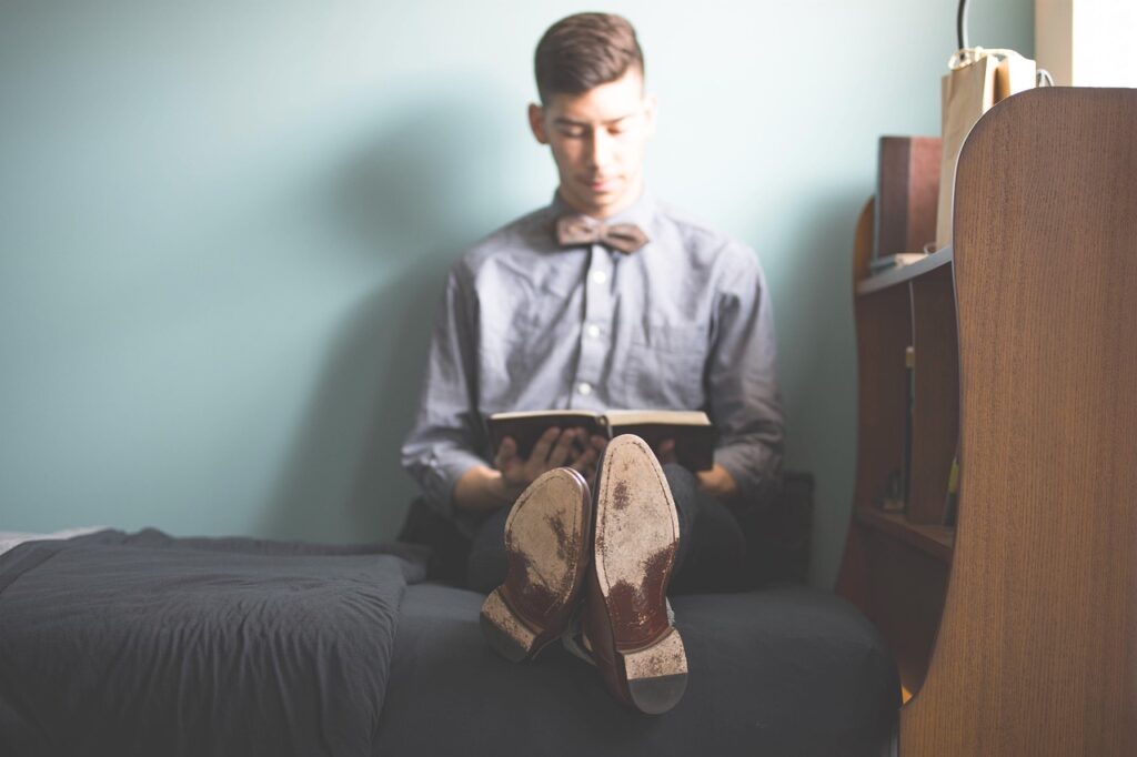 Man Studying on His Bed